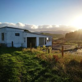 small cottage in a farm with clear sunny sky.