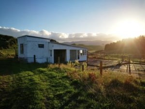 small cottage in a farm with clear sunny sky.