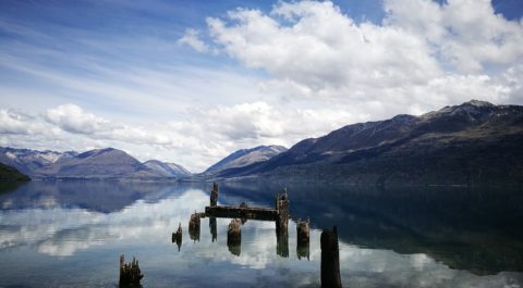 lake wakatipu and reflection of mountainous range on its calm water