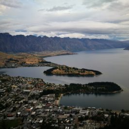 Queenstown and lake wakatipu from Skyline gondola with mountain background and cloudy sky