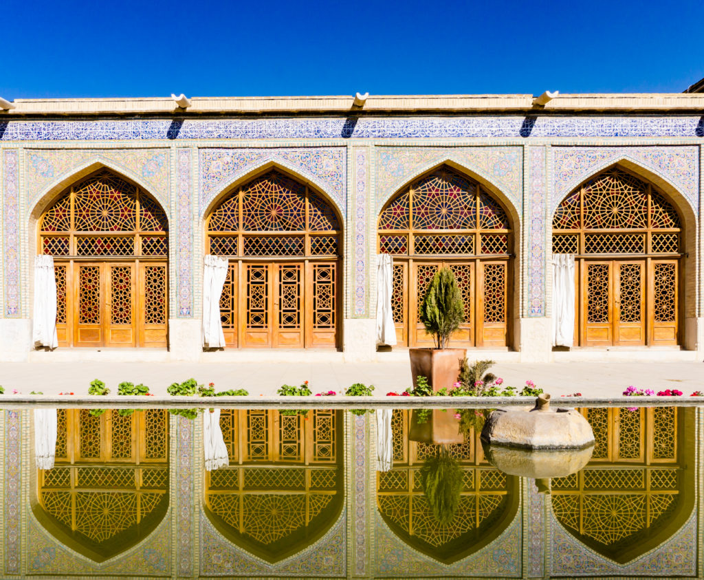 exterior building of Nasr al-molk masjid with a reflection on water