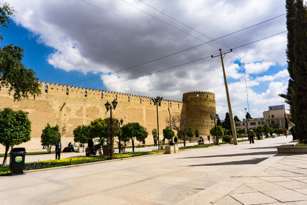 A citadel in the middle of a city under cloudy sky